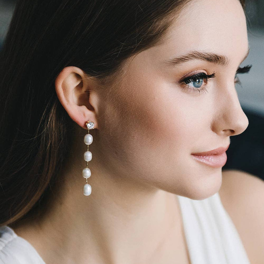 Elevate your everyday elegance with the understated beauty of our Dream Pearl Dangle Earrings — a timeless accessory designed for modern romantics. Featuring a delicate cubic zirconia stud and a graceful string of luminous freshwater pearls, these earrings strike the perfect balance between simplicity and sophistication.