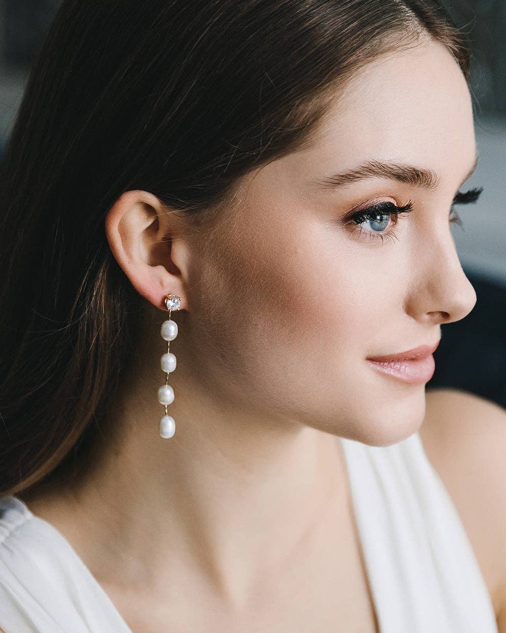 Elevate your everyday elegance with the understated beauty of our Dream Pearl Dangle Earrings — a timeless accessory designed for modern romantics. Featuring a delicate cubic zirconia stud and a graceful string of luminous freshwater pearls, these earrings strike the perfect balance between simplicity and sophistication.