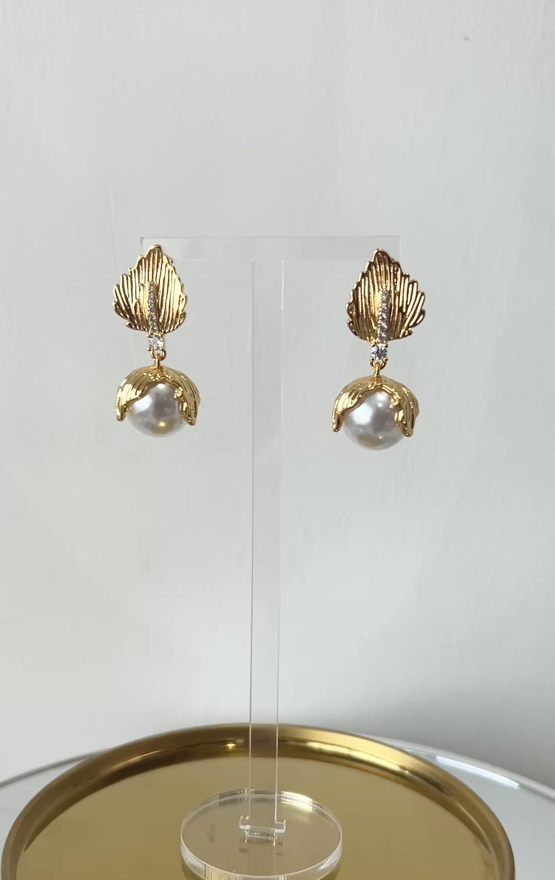 Video clip of gold earrings with pearl drop