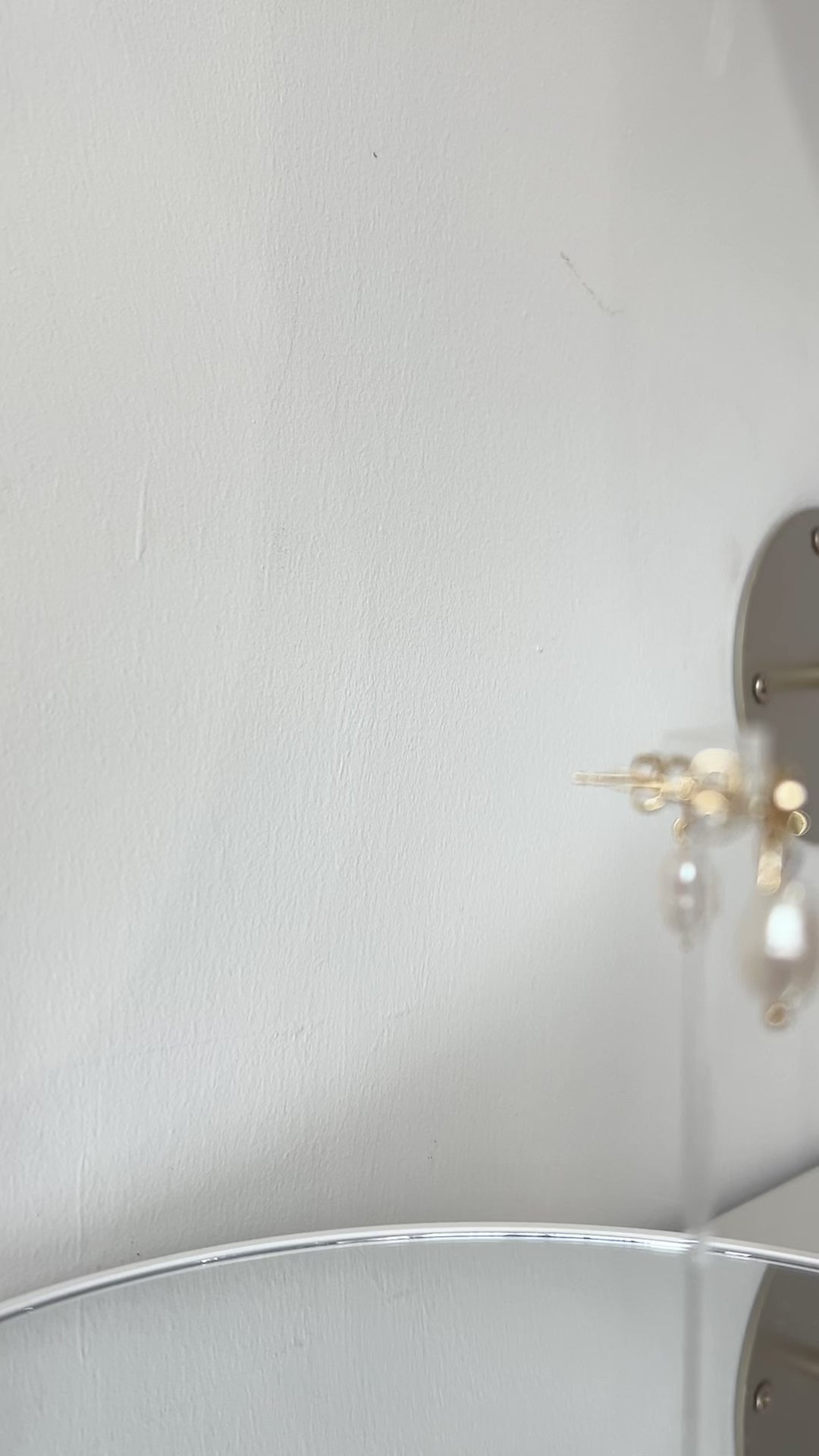 Video of delicate gold bow earrings with a freshwater pearl drop